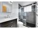 Modern bathroom featuring walk-in glass shower and sleek vanity at 5000 W Dakota Ave, Denver, CO 80219