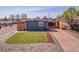Attractive home exterior with a manicured lawn, landscaping, and a covered parking space at 5000 W Dakota Ave, Denver, CO 80219