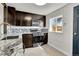 Modern kitchen with granite countertops, stainless steel appliances, and stylish backsplash at 5000 W Dakota Ave, Denver, CO 80219