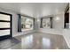Bright living room featuring hardwood floors, natural light, and stylish wall sconces at 5000 W Dakota Ave, Denver, CO 80219
