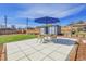 Backyard patio with table, chairs, and an umbrella at 5000 W Dakota Ave, Denver, CO 80219