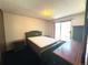 Bedroom featuring sliding glass doors to balcony and neutral walls and carpeting at 2986 W 119Th Ave, Westminster, CO 80234