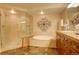 A fully equipped bathroom featuring a glass shower and a spa tub at 8100 E Union Ave # 1502, Denver, CO 80237