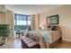 Comfortable bedroom features a large window, seating area, and stylish decor at 8100 E Union Ave # 1502, Denver, CO 80237