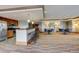 Bright community room boasts a kitchenette with modern appliances and ample seating at the bar and surrounding tables at 8100 E Union Ave # 1502, Denver, CO 80237