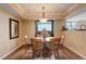 Bright dining room featuring a round table, seating for four, and views from the large window at 8100 E Union Ave # 1502, Denver, CO 80237