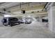 Secured parking garage featuring assigned spaces and multiple cars, including a black SUV at 8100 E Union Ave # 1502, Denver, CO 80237