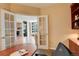 Well-lit home office showcasing French doors leading to the main living space at 8100 E Union Ave # 1502, Denver, CO 80237