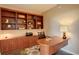 Well-appointed home office with custom built-in shelving and a stylish desk area at 8100 E Union Ave # 1502, Denver, CO 80237