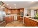 Updated kitchen with stainless steel appliances, wood cabinets and tile floors at 8100 E Union Ave # 1502, Denver, CO 80237