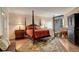 Warm main bedroom with hardwood floors and access to an outdoor balcony at 8100 E Union Ave # 1502, Denver, CO 80237
