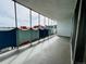 The balcony features metal railings and views of the city skyline and blue sky at 1155 N Ash St # 908, Denver, CO 80220