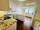 Well-lit kitchen with white cabinets, stone countertops, and modern appliances at 1155 N Ash St # 908, Denver, CO 80220