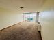 Bright living room featuring carpeted floors, light walls, and access to the balcony with sliding glass doors at 1155 N Ash St # 908, Denver, CO 80220