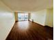 Spacious living room with gleaming hardwood floors and lots of natural light from a large window at 1155 N Ash St # 908, Denver, CO 80220