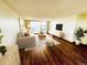 Bright living room featuring a sliding door to a balcony, hardwood floors, and comfortable seating arrangements at 1155 N Ash St # 908, Denver, CO 80220