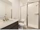 Modern bathroom featuring a sink with a vanity and a glass shower with white subway tile at 10720 Snowdon St, Parker, CO 80134