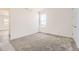 Bright bedroom features neutral walls, cozy carpet, and a window allowing natural light at 10720 Snowdon St, Parker, CO 80134