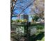 View of Zeckanbark Dog Park with green grass, trees, and a fence with dog park signs at 960 N Sherman St # 2G, Denver, CO 80203