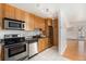 Functional kitchen with wood cabinets, stainless steel appliances, and easy access to dining area at 960 N Sherman St # 2G, Denver, CO 80203