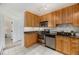 Well-maintained kitchen with wood cabinets, stainless steel appliances, granite countertops and tile floor at 960 N Sherman St # 2G, Denver, CO 80203