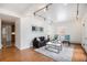 Bright living room featuring hardwood floors, a modern sofa, art, track lighting, and natural light at 960 N Sherman St # 2G, Denver, CO 80203