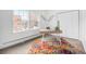 Bright office space featuring large window, colorful rug and minimalist desk at 960 N Sherman St # 2G, Denver, CO 80203