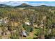 From above, the house appears serene amongst the dense foliage of trees, providing a secluded and private atmosphere at 10893 Milliken Ave, Conifer, CO 80433
