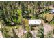 Birds eye view of the property with trees, sheds, trampoline, and neighboring houses nearby at 10893 Milliken Ave, Conifer, CO 80433