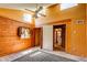 Sunlit bedroom with wooden accent wall and vaulted ceiling at 10893 Milliken Ave, Conifer, CO 80433