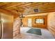 Kitchen and dining with wood paneling, stainless appliances, and natural light, ideal for a cozy living space at 10893 Milliken Ave, Conifer, CO 80433