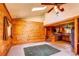 An open living space featuring wood walls, skylight, and vaulted ceiling flowing into the kitchen at 10893 Milliken Ave, Conifer, CO 80433