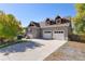 Two-story home with attached two-car garage and a well-manicured lawn at 10527 W 69Th Pl, Arvada, CO 80004