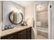 Modern bathroom with updated vanity, decorative granite countertop, sink, and a view of the shower at 800 N Pearl St # 1109, Denver, CO 80203