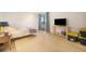 Well-lit bedroom features a TV, an access to a small patio, and soft carpet flooring at 800 N Pearl St # 1109, Denver, CO 80203