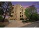 Modern high-rise exterior with surrounding landscaping and signage at dusk at 800 N Pearl St # 1109, Denver, CO 80203