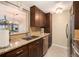 Well-lit kitchen with wood cabinets, granite counters, stainless appliances, and easy access to other rooms at 800 N Pearl St # 1109, Denver, CO 80203