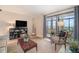 Cozy living room featuring a city view from the balcony, warm natural light, and neutral decor at 800 N Pearl St # 1109, Denver, CO 80203
