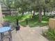 A cozy patio area overlooks a well-maintained green space with mature trees, creating a tranquil outdoor living space at 800 N Pearl St # 1109, Denver, CO 80203