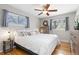 Bright bedroom with a king-size bed, dresser, and ceiling fan at 12482 W Mississippi Ave, Lakewood, CO 80228