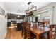 Open concept dining area with wood dining table and kitchen view at 12482 W Mississippi Ave, Lakewood, CO 80228