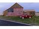 Rustic barn adorned with American flag art, complemented by a classic red pickup truck at 39743 Penn Rd, Elizabeth, CO 80107
