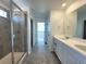 Bathroom features a double sink vanity, a glass-enclosed shower, and neutral color scheme at 39743 Penn Rd, Elizabeth, CO 80107