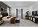 Spacious bedroom featuring a modern accent wall, sitting area, and decorative console table with television at 39743 Penn Rd, Elizabeth, CO 80107