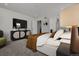 Modern bedroom with a platform bed, stylish console table, and a sleek wall-mounted television at 39743 Penn Rd, Elizabeth, CO 80107