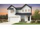 Modern farmhouse exterior showcasing white siding, dark trim, and an inviting front porch at 39743 Penn Rd, Elizabeth, CO 80107