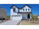 Charming two-story home with white siding, black trim, and a spacious two-car garage at 39743 Penn Rd, Elizabeth, CO 80107