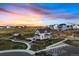 A two-story white home with a garden in a community at sunset at 39743 Penn Rd, Elizabeth, CO 80107