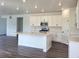 Modern kitchen with white cabinets, quartz countertops, a central island, and stainless steel appliances at 39743 Penn Rd, Elizabeth, CO 80107