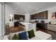 Well-lit open kitchen with stainless appliances, a large island, and seamless transition into the living room at 39743 Penn Rd, Elizabeth, CO 80107